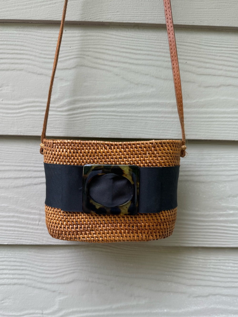 Bosom Buddy Bags crossbody bag with a tortoise shell buckle.